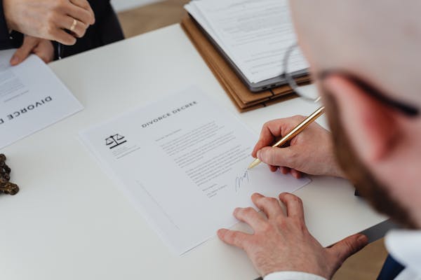 Client signing a will with an attorney at a Central Arkansas law office